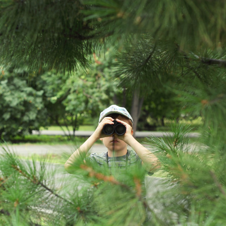 Cute little boy playing with the binocularの写真素材