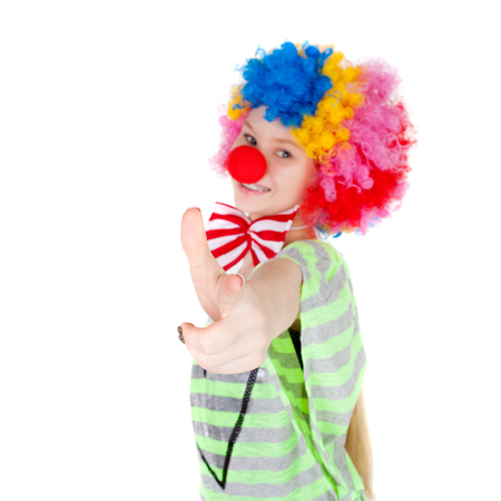 cute teen girl dressed as a clown, focus on the handの写真素材