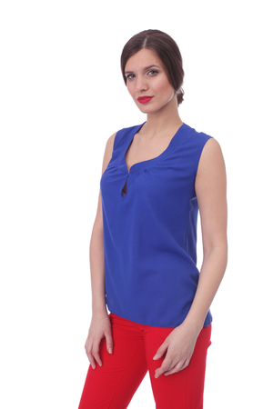 pretty young girl wearing blue blouse with red pantsの写真素材