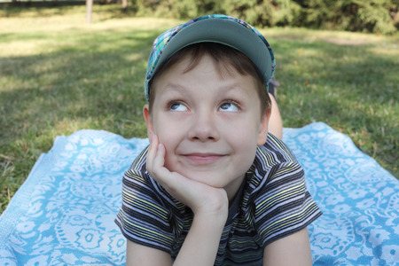 cute little boy relaxing in a park