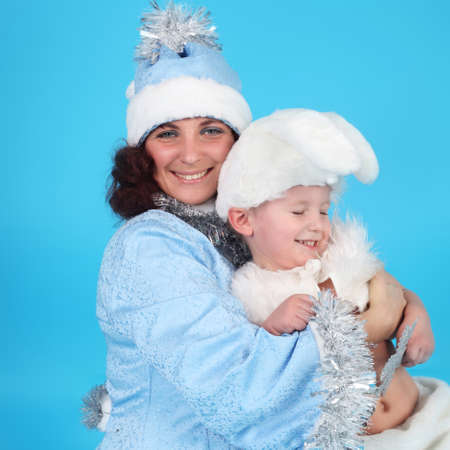 Young woman in a Snow Maiden costume with a baby in a costume of rabbitの写真素材