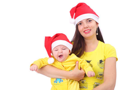 Young pretty woman with a small baby in Christmas capsの写真素材