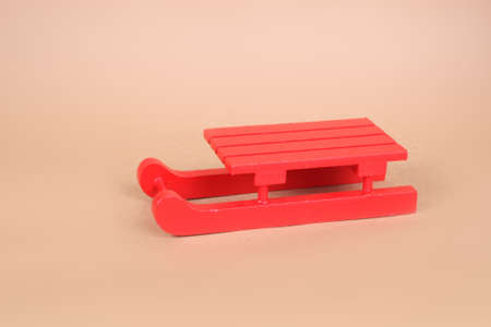 red wooden sledge christmas souvenir on the beige backgroundの写真素材