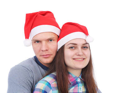 pretty young couple wearing Santa Claus capsの写真素材