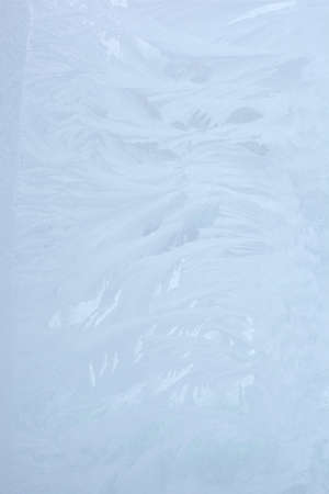 blue winter ice ornament on the glassの写真素材