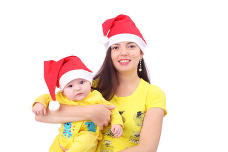 pretty happy young mother with the cute little baby dressed in new year capsの写真素材