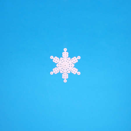 White small snowflake closeup on the blue backgroundの写真素材
