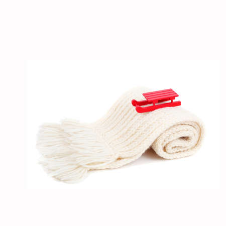 red wooden sledge christmas souvenir on the white scarf mountainの写真素材