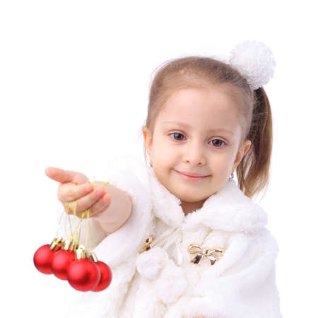 little girl holding red New Year ballsの写真素材