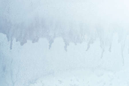 blue winter ice ornament on the glassの写真素材