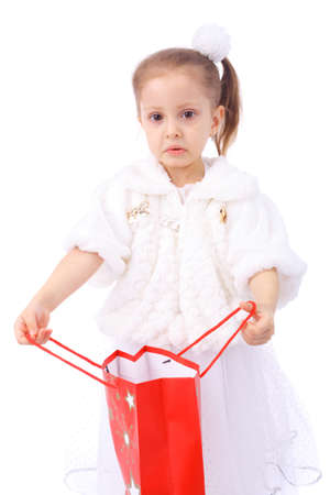 cute little girl dissapointed with the empty holiday gift bagの写真素材