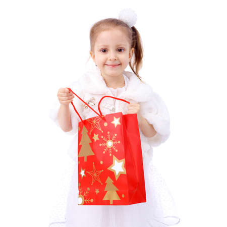 cute little girl with the holiday gift bagの写真素材
