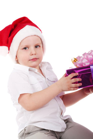 cute little boy in Santa Clause's cap with the giftの写真素材