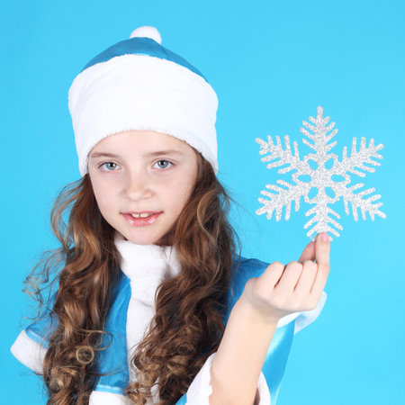 pretty little Snow Maiden with a snowflake in her handの写真素材