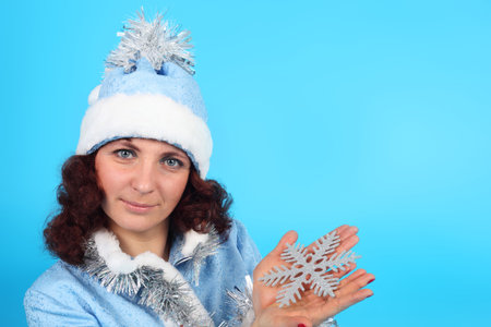 pretty young Snow Maiden with the snowflake in her handの写真素材