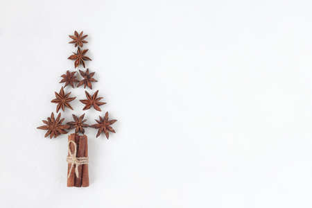 new year tree made of stars anise and cinnamon sticks, white background, top view, copy space, idea for a Christmas cardの写真素材