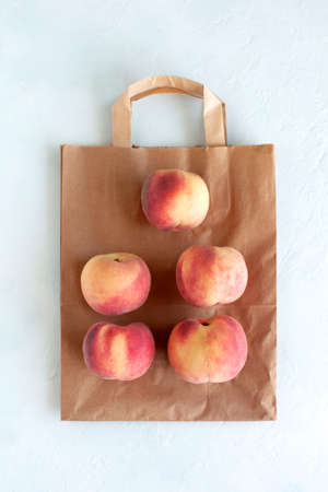 Fresh peaches on the paper bag, zero wasteの写真素材