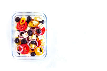 lunchbox containing greek salad, concept of healthy food and zero waste, on white background, top view, copy spaceの写真素材