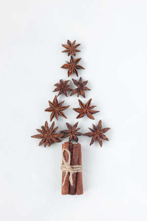 new year tree made of stars anise and cinnamon sticks, white background, top viewの写真素材