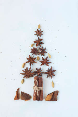 new year tree made of stars anise and cinnamon sticks, white background, top viewの写真素材