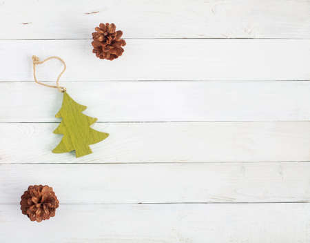 new year tree made of wood and natural cones on the white wooden background, rustic style, concept of minimalism, top view, copy spaceの写真素材