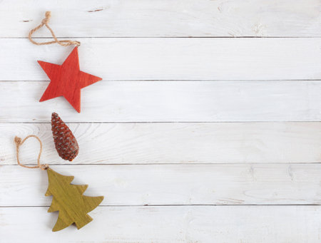 new year decoration made of wood and natural cone on the white wooden background, rustic style, concept of minimalism, top view, copy spaceの写真素材