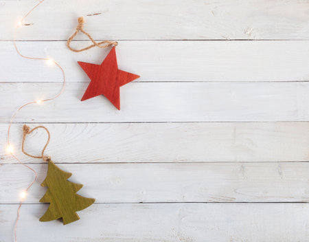 new year tree decoration made of wood and garland on the white wooden background, top view, copy spaceの写真素材