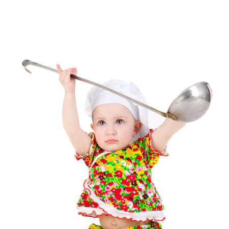 cute sweet little baby in the cook cap and with the big ladleの写真素材