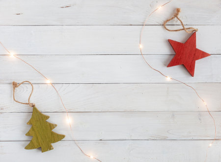 new year tree decoration made of wood and garland on the white wooden background, top view, copy spaceの写真素材