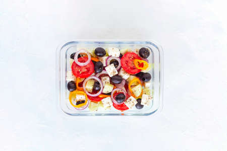 lunch box with greek salad, glass container, white background, top viewの写真素材
