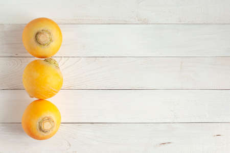 Three bright turnips on wooden background, copy spaceの写真素材