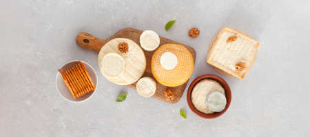 different types of cheese on gray concrete background, top view, bannerの写真素材