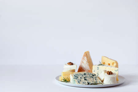 cheese plate with different types of french cheese on white background, copy spaceの写真素材