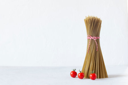 New Year tree made of quinoa, spaghetti gluten free, decorated with tomatoes cherry, copy spaceの写真素材