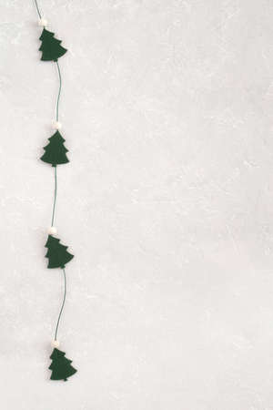 New Year and Christmas trees garland on gray background, copy spaceの写真素材