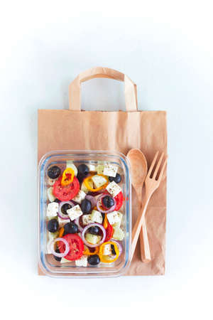 Lunch box with greek salad on the craft paper bagの写真素材