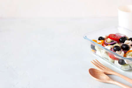 Lucnhbox with greek salad on white backgroundの写真素材