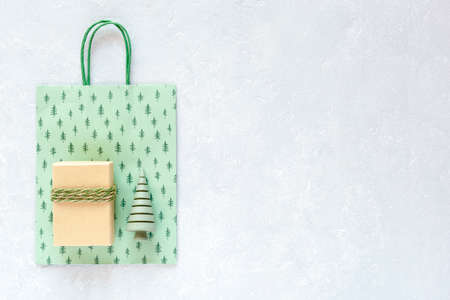 Christmas and New Year set of paper gift bag, craft paper gift box and decorative wooden mini Christmas tree, copy spaceの写真素材
