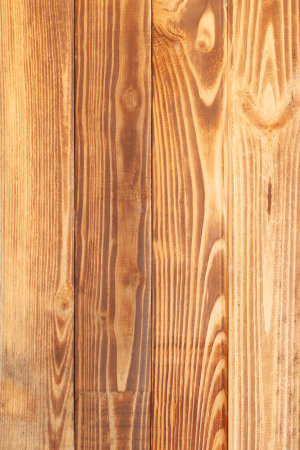 yellow and brown raw wooden vertical planks used like backgroundの写真素材