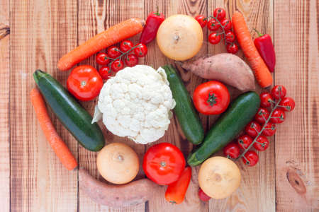 raw vegetables on wooden background, top view, concept of healthy foodの写真素材