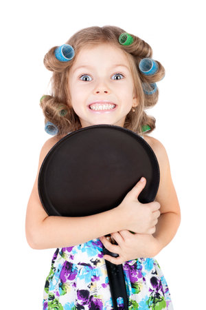 cute funny little girl wearing the curler and with the panの写真素材