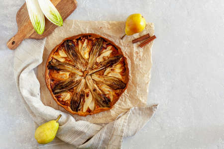 Homemade endive, pear and gorgonzola tart, flatlay, copy spaceの写真素材