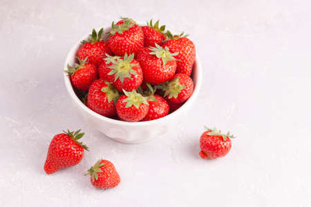 White bowl of fresh red strawberries closeupの写真素材