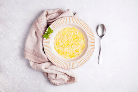 potato and pasta soup in a plate, gray background, top viewの写真素材