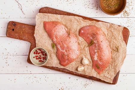 Two pieces of raw veal prepared to cook on a wooden cutting boardの写真素材