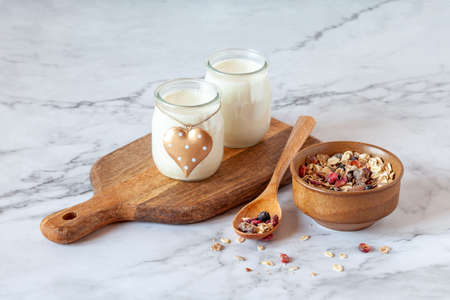 Milk joghurt with bowl of muesli, breakfast ideaの写真素材