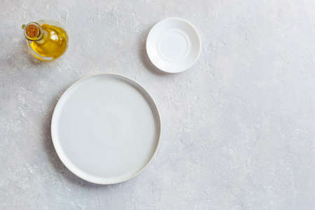 mockup white empty serving dish, small plate and olive oil pitcher, top view, copy spaceの写真素材