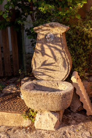 Ancient stone drinking fountain in an old european villageの写真素材