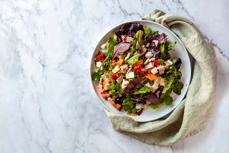 Portion of bacon, tomato, cheese and bell pepper salad, top viewの写真素材