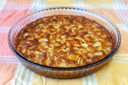 Apple pie in a glass mold on a yellow napkinの写真素材